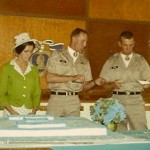Paula Lukey, Bob Turner and Richard Epting cutting cake with bayonet